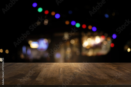 Empty of dark wooden table in front of abstract blurred background of bokeh light . can be used for display or montage your products.Mock up for display of product