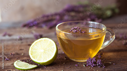 Green tea with herbals and lime. Tea with oregano on the wooden background