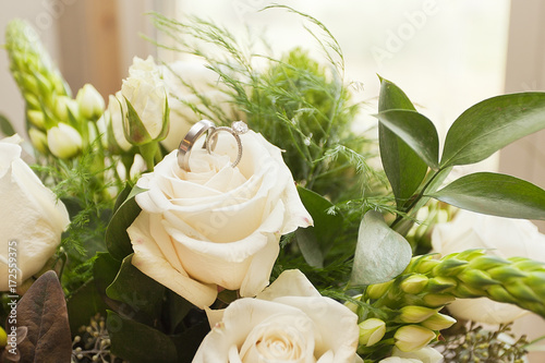 Wedding rings on top of roses  