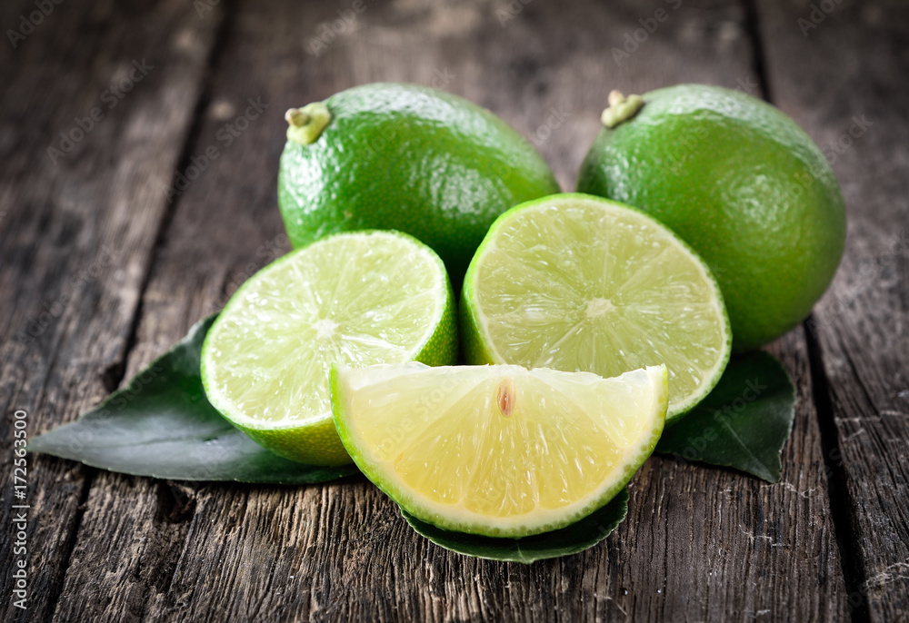 Fresh ripe limes on wooden background. Fresh ripe limes on wooden background.