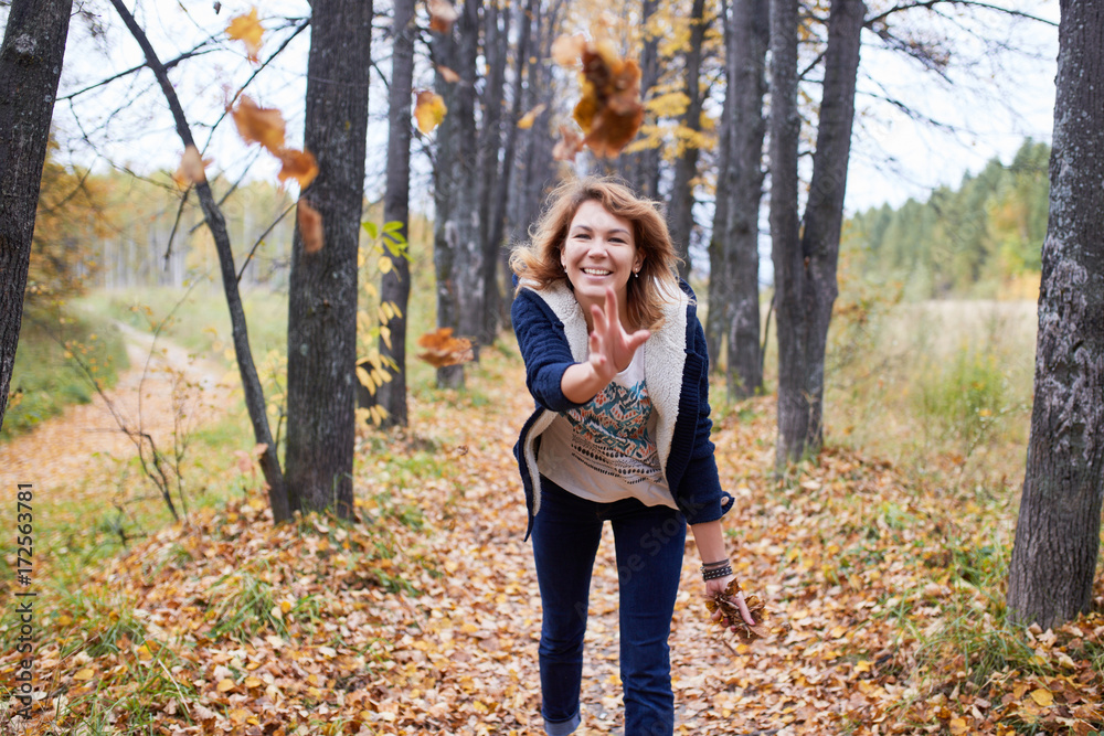Portrait of a woman in an autumn forest. Portrait of a girl in yellow leaves Portrait of a woman in an autumn forest. Portrait of a girl in yellow leaves