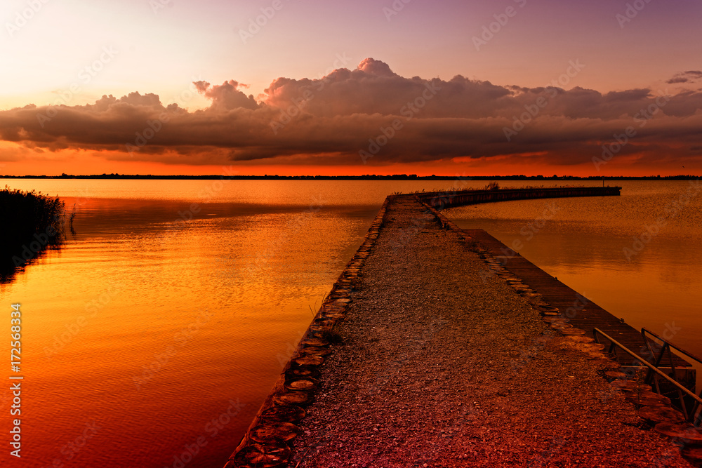 Sunset over calm lake. Colorful and vibrant landscape of lake