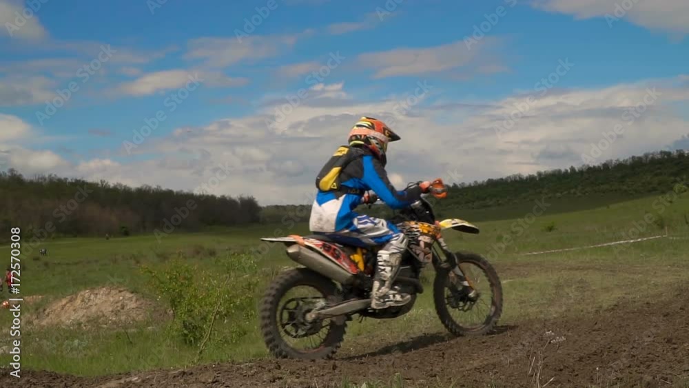 Enduro racer in motorcycle. Off-road motorbike rides. Slow motion Enduro racer in motorcycle. Off-road motorbike rides. Slow motion