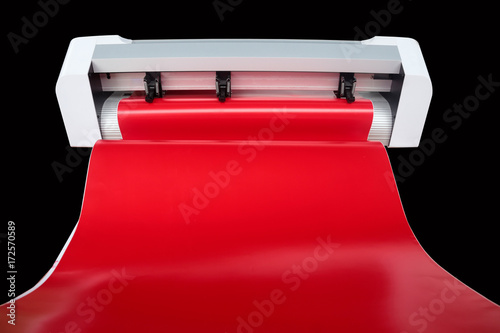 Sticker machine and red sticker sheet ready to cutting stickers for use different types of jobs.