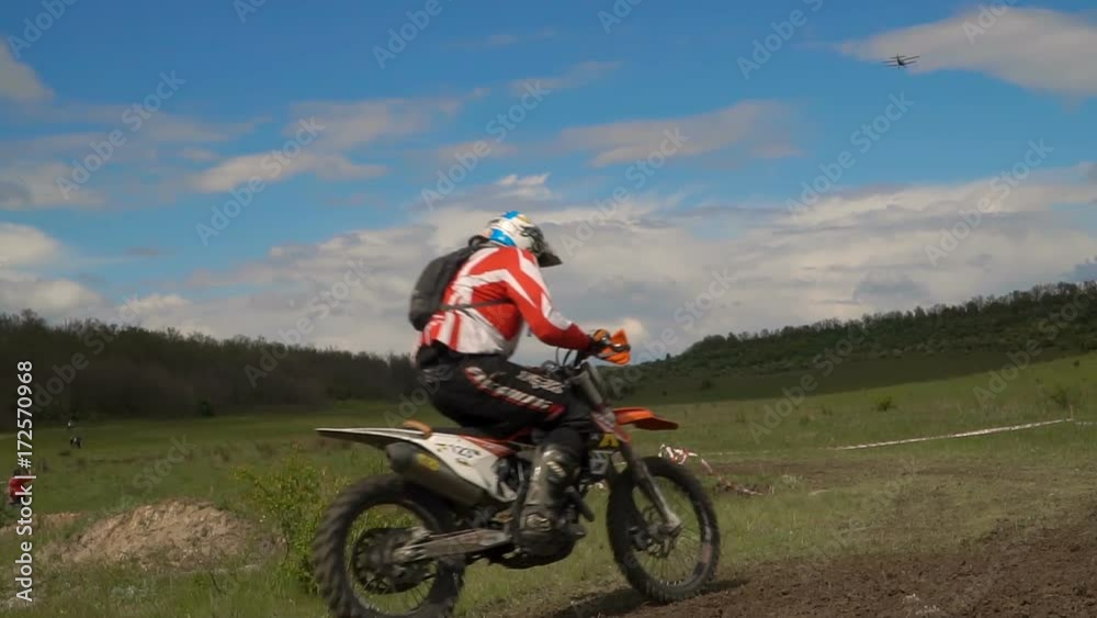 Professional motor biker jumping over in slow motion on a motocross track. Professional motor biker jumping over in slow motion on a motocross track.