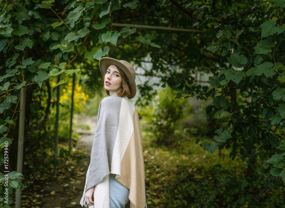 Fashionable young woman wearing in hat and poncho. Fashionable young woman wearing in hat and poncho.