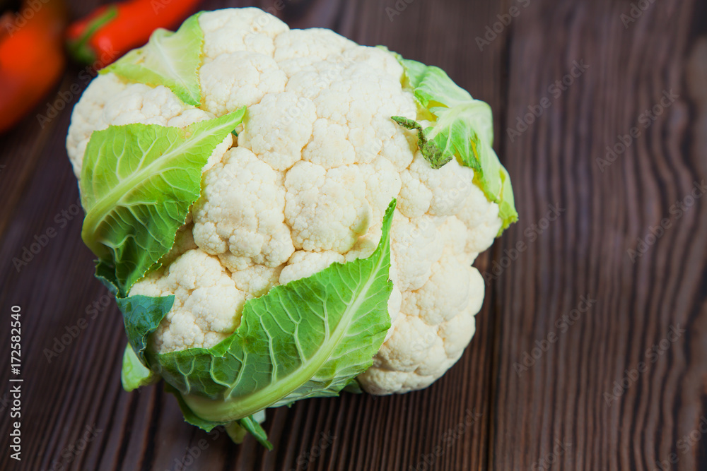 Raw fresh cauliflower on wooden table Raw fresh cauliflower on wooden table