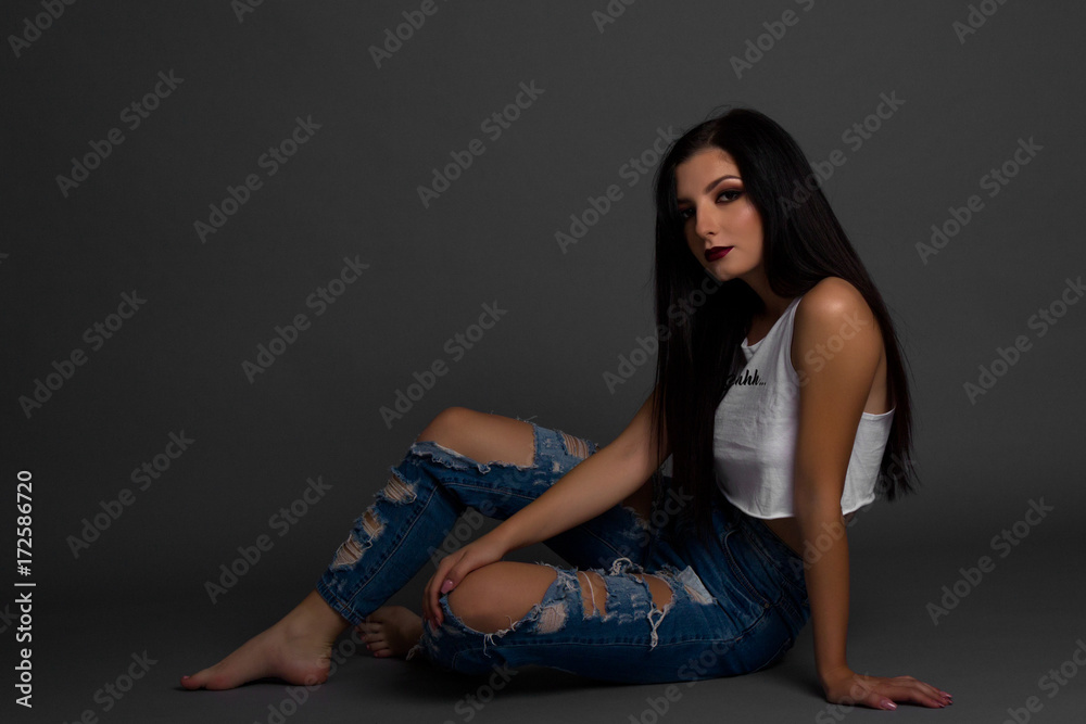 Young woman sitting on the floor Young woman sitting on the floor