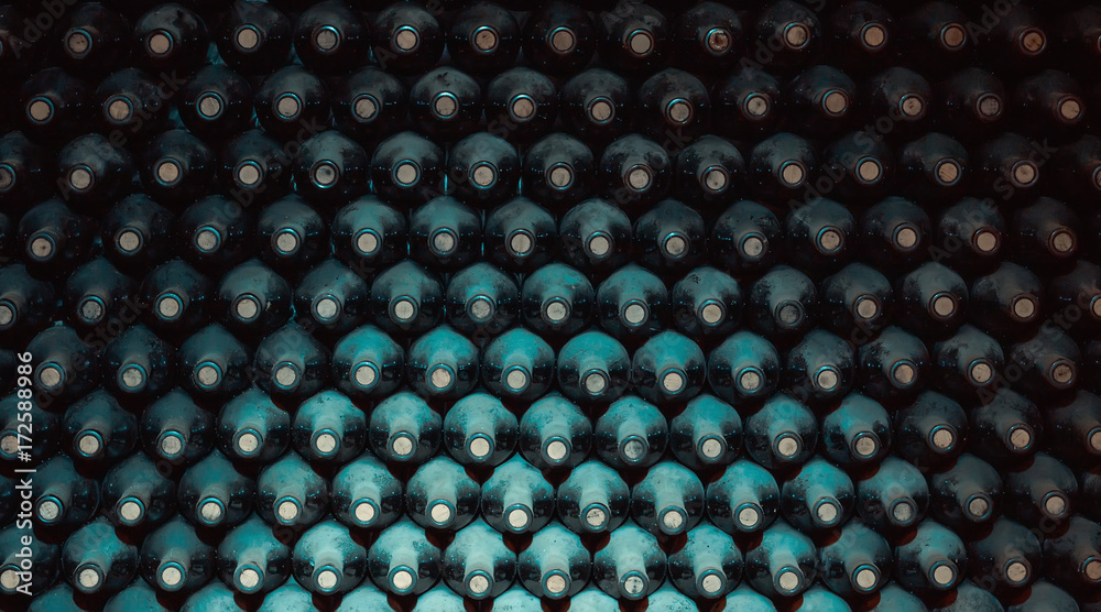 stacked up wine bottles in the cellar