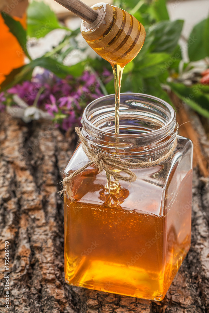 Honey bowl with dipper and flowing honey Honey bowl with dipper and flowing honey