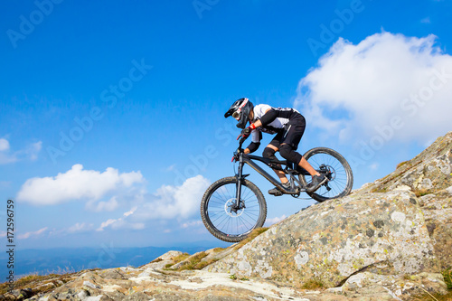 A man is riding enduro bicycle.