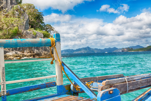 view of the island hill from the prow of a boat