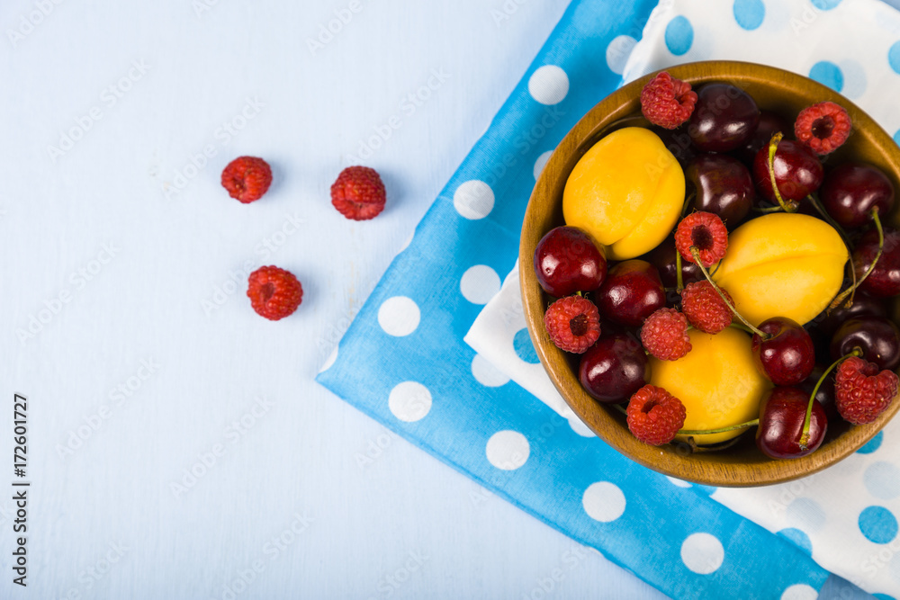 Ripe berries in a plate on a wooden table. Ripe berries in a plate on a wooden table.