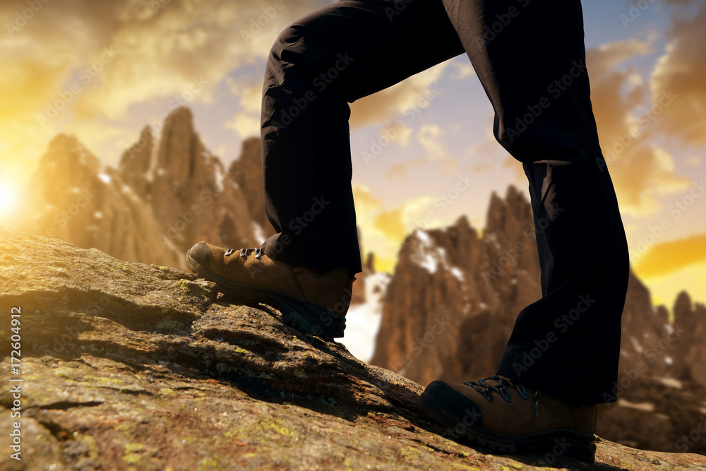 Mountain hiker on a trip in the sunset, Dolomites Alps, Italy.