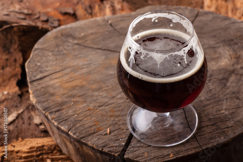 Dark beer on stump photo