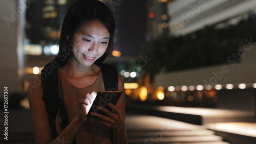 Photography Woman use of smart phone in Hong Kong at night