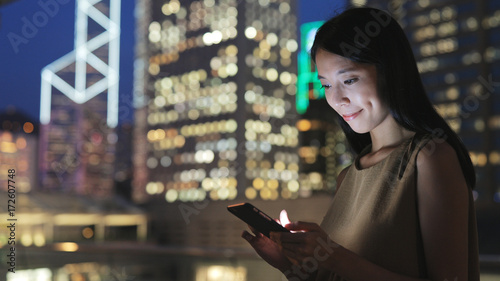Canvas Print Woman text on cellphone at night