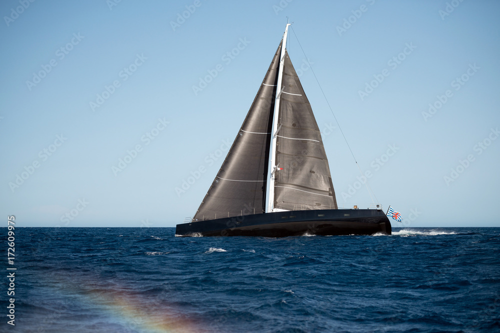 Black sailing yacht on the sea