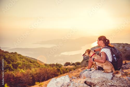 Woman with a dog on a mountain top