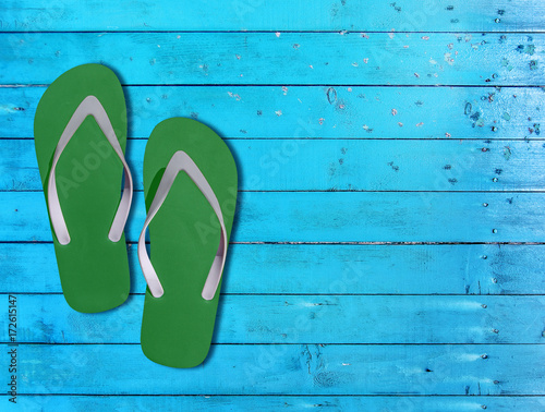 Two green man lifestyle relax flip flops on blue wooden floor