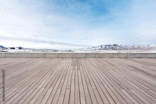empty wooden floor with beautiful snow mountains