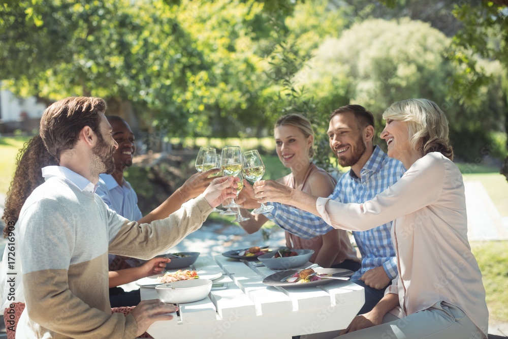 Group of friends toasting glasses of wine in a restaurant Group of friends toasting glasses of wine in a restaurant