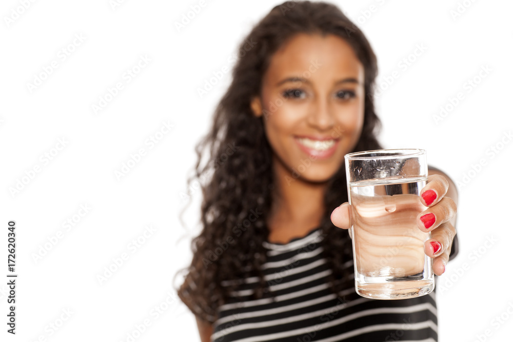 young beautiful african girl holding a galass of water on white background young beautiful african girl holding a galass of water on white background