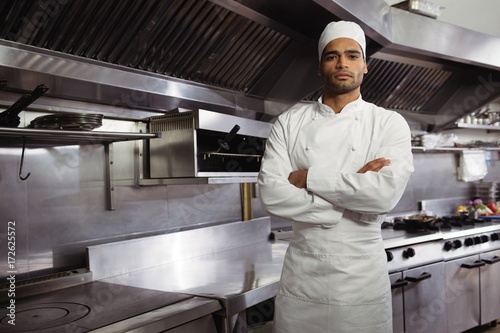 Portrait of confident chef standing with arms crossed in