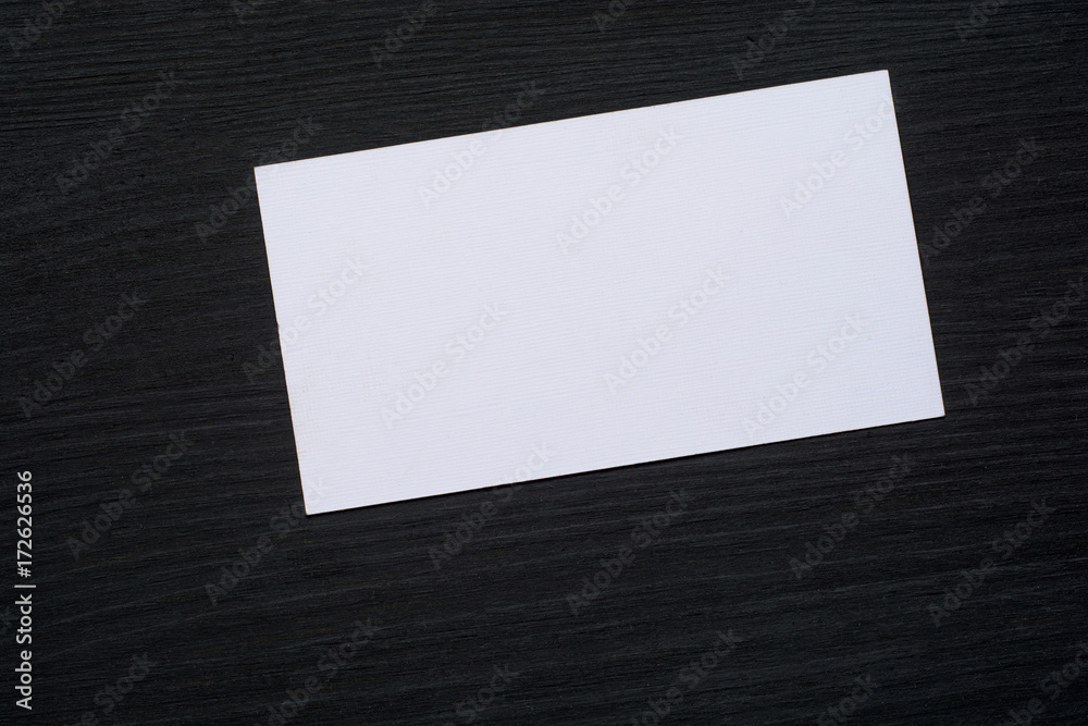 Photo of blank white business cards on a dark wooden background. Mock-up for branding identity. Photo of blank white business cards on a dark wooden background. Mock-up for branding identity.