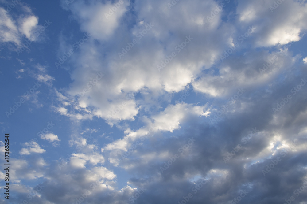 cumulus white clouds against a beautiful blue sky, bizarre patte