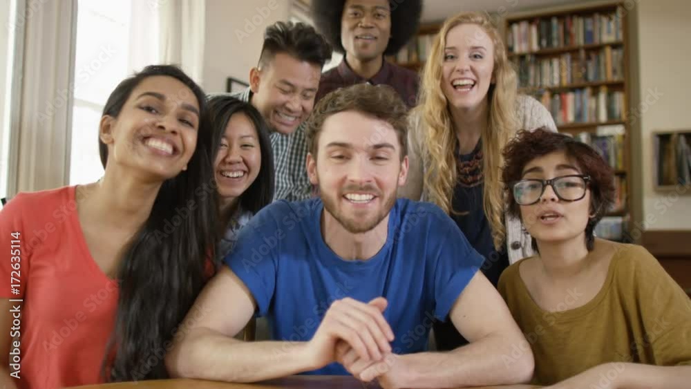 Happy group of student friends making a video call in shared accommodation. As seen from webcam's pov. Happy group of student friends making a video call in shared accommodation. As seen from webcam's pov.