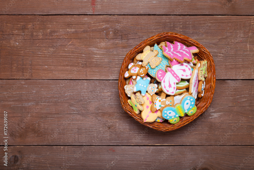 Gingerbread homemade cookies with icing colored drawings on wooden table Gingerbread homemade cookies with icing colored drawings on wooden table