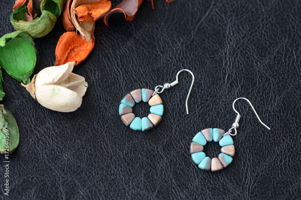 Round beaded earrings aquamarine and bronze color close up Round beaded earrings aquamarine and bronze color close up