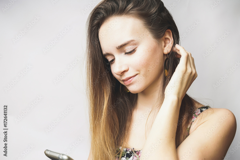 Fototapeta premium Beautiful young woman with mobile phone texting,looking something