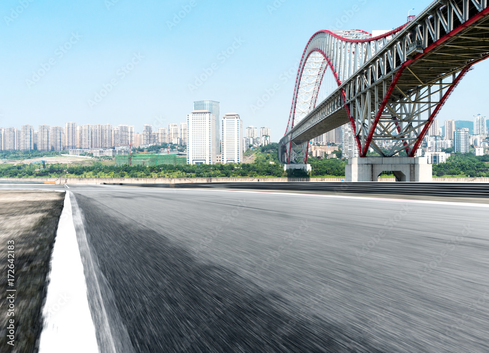 Fototapeta premium empty asphalt road with cityscape of modern city