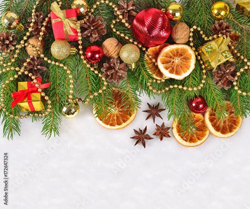 Dried oranges and cones, Christmas decorations and spruse branch on a white