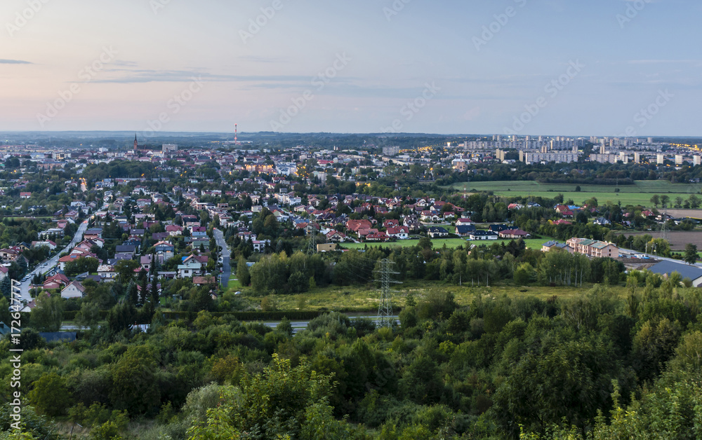 Diverse city landscape in the evening. View on the estate of single family homes and multifamily residential.