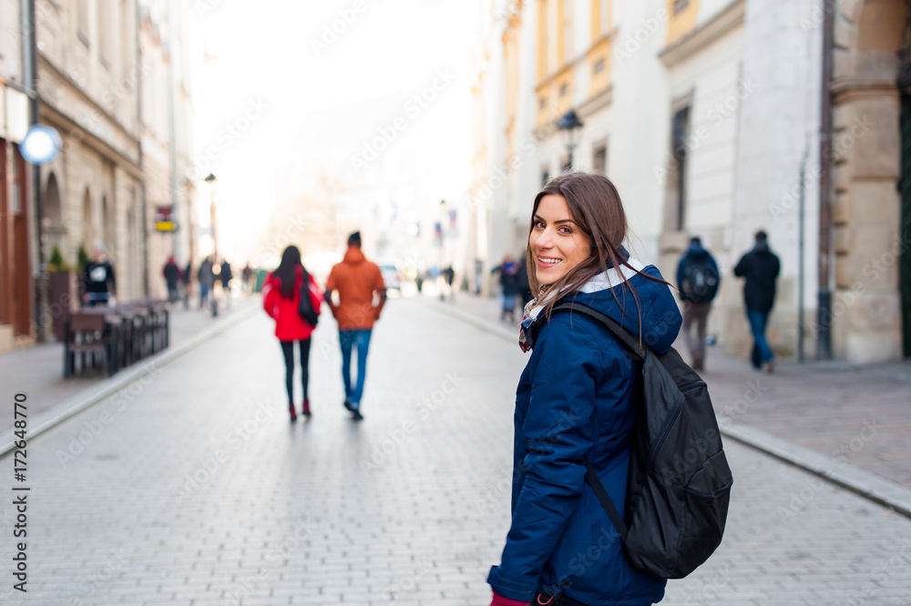 Young woman tourist in the city of Kracow , Poland, visiting the city.