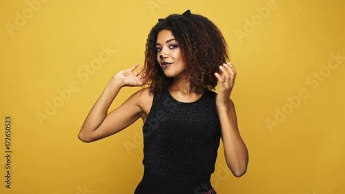 Beautiful african woman smarten up her hair and smiling at camera isolated  photo