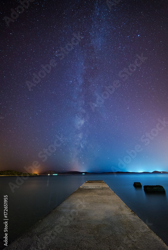 Night scene with stone pier and starry sky
