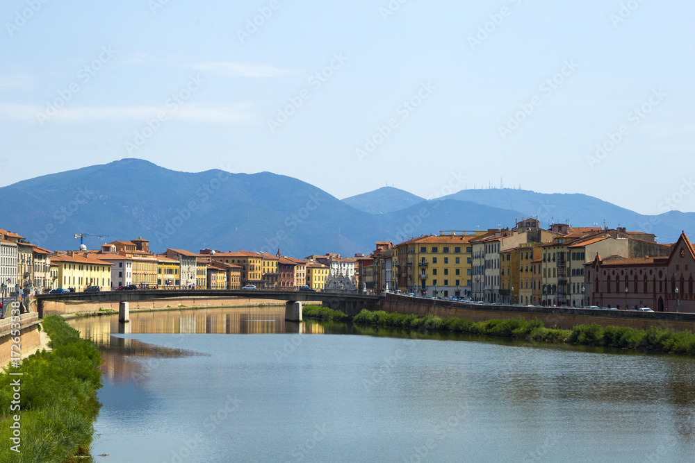 view on landscape of the bridge, the mountains and the river Arno in Pisa, Italy