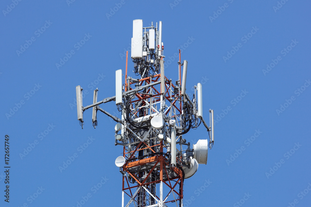 Antenna tower,antenna tower building with the blue sky.Close-up of the antenna building with the sky background. Antenna tower,antenna tower building with the blue sky.Close-up of the antenna building with the sky background.