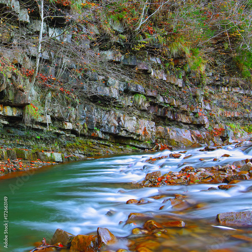 Fototapeta Naklejka Na Ścianę i Meble -  Rocky shore of river in autumn time.