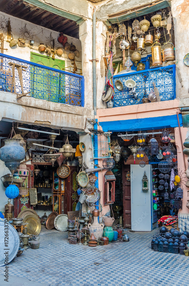 Huge selection of pots, lamps, lantern and other metal works in shop of souk in medina of Fez, Morocco, North Africa