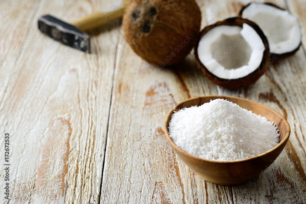 Grated coconut with its shell on background Grated coconut with its shell on background