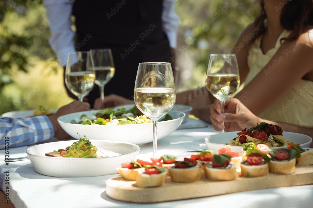Close-up of food and wine glass on dining table Close-up of food and wine glass on dining table