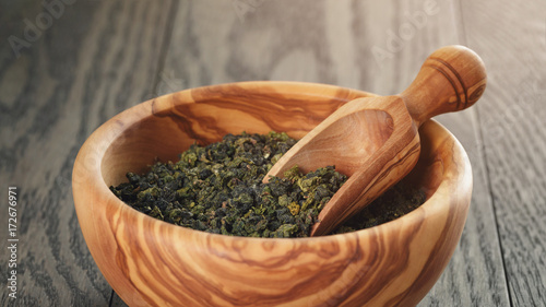 oolong green tea in wood bowl