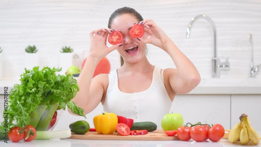 Beauty young funny woman holding fresh vegetables and smiling in her kitchen at home. Healthy eating concept. 4K UHD video footage. Ultra high definition 3840X2160 Beauty young funny woman holding fresh vegetables and smiling in her kitchen at home. Healthy eating concept. 4K UHD video footage. Ultra high definition 3840X2160