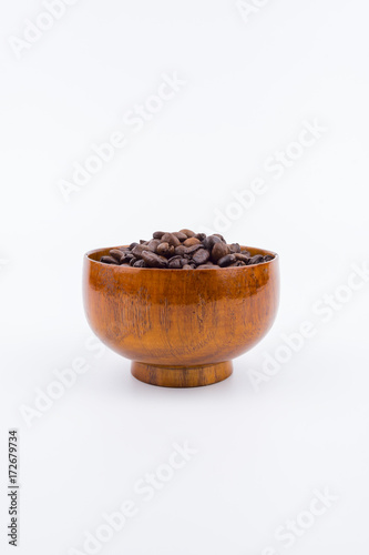 Concept roasted coffee beans in wooden bowl with isolated white background