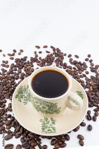 Concept roasted coffee beans and hot coffee with isolated white background © Muhamad